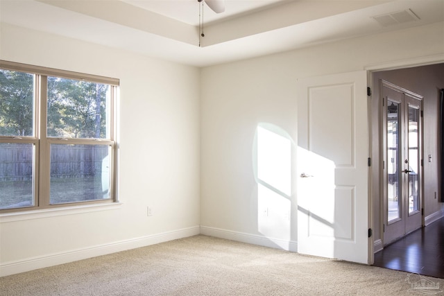 spare room with carpet floors, plenty of natural light, and ceiling fan