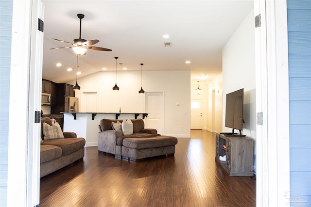 living room featuring dark hardwood / wood-style floors, ceiling fan, and lofted ceiling