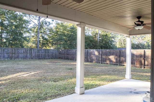 view of yard with ceiling fan and a patio