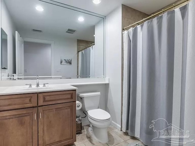 bathroom with vanity, tile patterned floors, and toilet