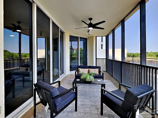 sunroom / solarium featuring ceiling fan