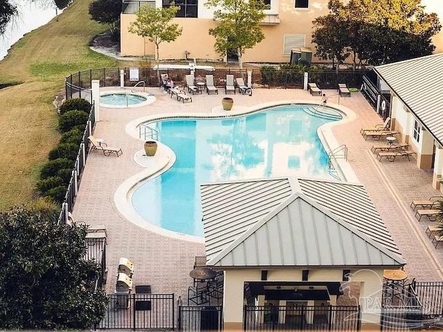 view of pool featuring a community hot tub and a patio area