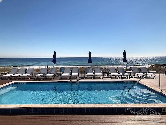 view of swimming pool featuring a water view