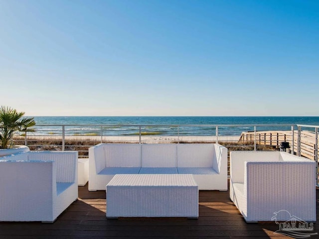 deck with a view of the beach, an outdoor hangout area, and a water view