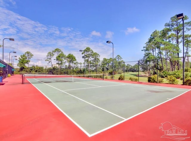 view of tennis court featuring basketball hoop