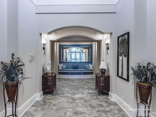 hallway featuring a high ceiling