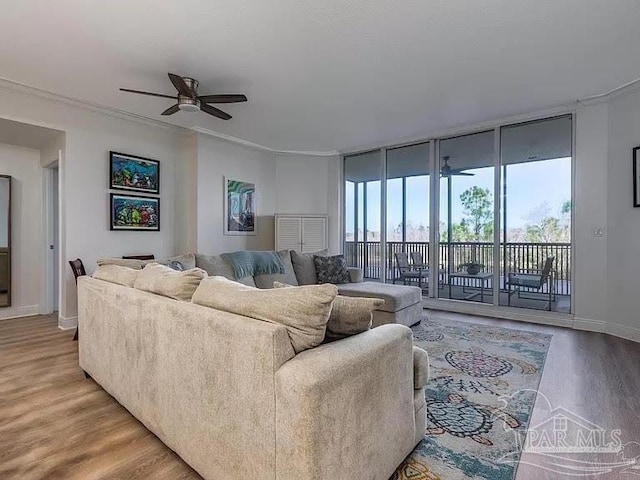 living room featuring expansive windows, crown molding, hardwood / wood-style floors, and ceiling fan