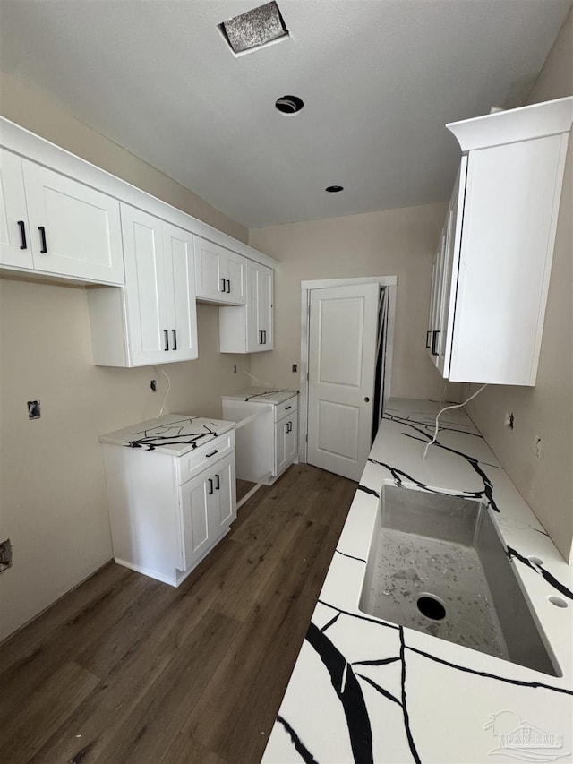 kitchen with white cabinetry and dark hardwood / wood-style flooring