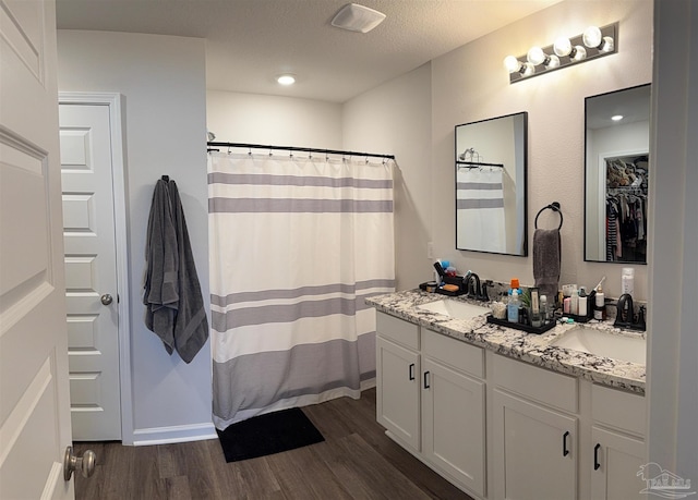4422 Tiger Oak Ct, Pace, FL 32571 - full bathroom featuring wood finished floors, double vanity, a shower with shower curtain, and recessed lighting