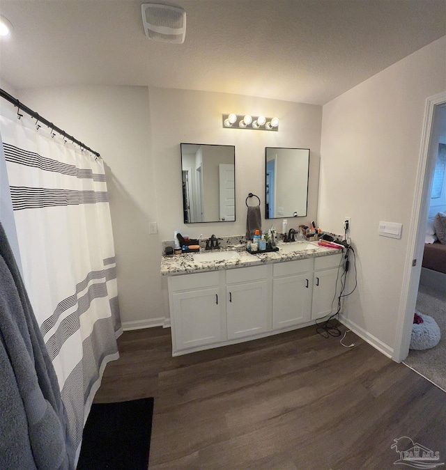 4422 Tiger Oak Ct, Pace, FL 32571 - bathroom featuring wood finished floors, baseboards, and double vanity