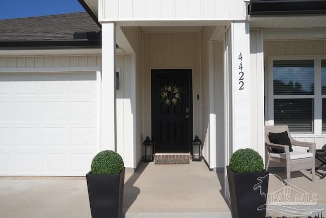 4422 Tiger Oak Ct, Pace, FL 32571 - view of exterior entry with an attached garage and roof with shingles