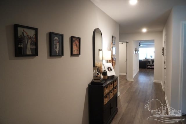 4422 Tiger Oak Ct, Pace, FL 32571 - hall with arched walkways, dark wood-style floors, and baseboards