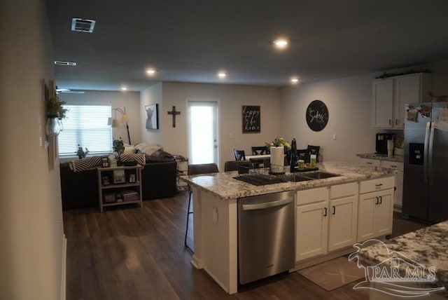4422 Tiger Oak Ct, Pace, FL 32571 - kitchen featuring stainless steel appliances, a center island with sink, dark wood-type flooring, open floor plan, and white cabinetry
