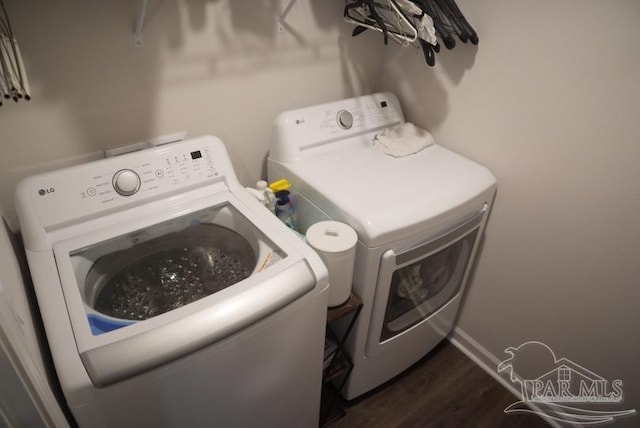 4422 Tiger Oak Ct, Pace, FL 32571 - laundry area featuring washing machine and dryer, dark wood finished floors, and baseboards