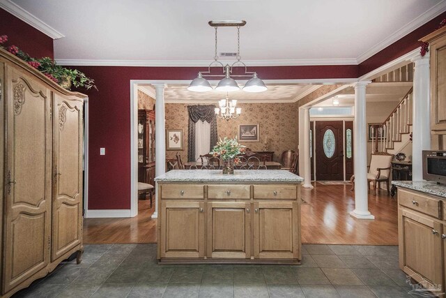 kitchen with ornamental molding, decorative columns, and pendant lighting