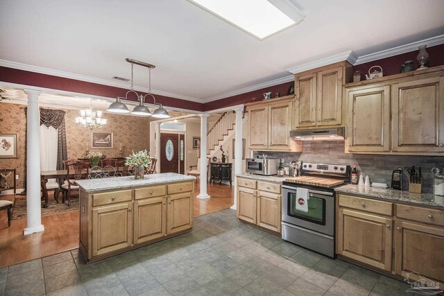 kitchen featuring decorative light fixtures, ornamental molding, appliances with stainless steel finishes, and decorative columns