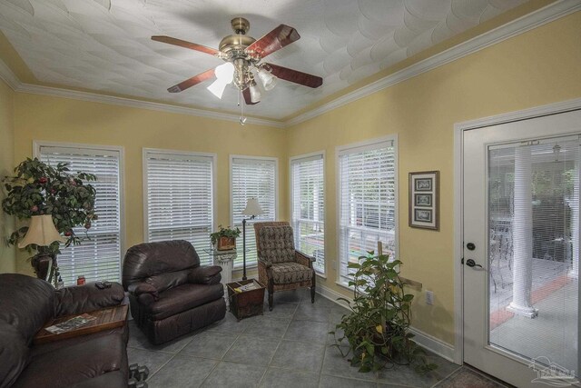 living room featuring ceiling fan, light tile patterned floors, and crown molding