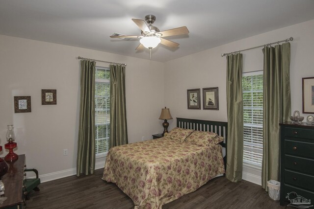 bedroom with dark hardwood / wood-style flooring and ceiling fan