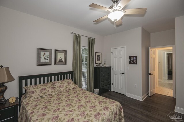 bedroom with ceiling fan and dark wood-type flooring