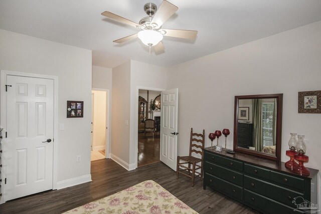 bedroom with dark hardwood / wood-style floors and ceiling fan