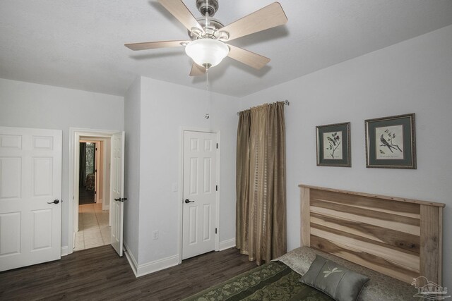 unfurnished bedroom featuring dark hardwood / wood-style flooring and ceiling fan