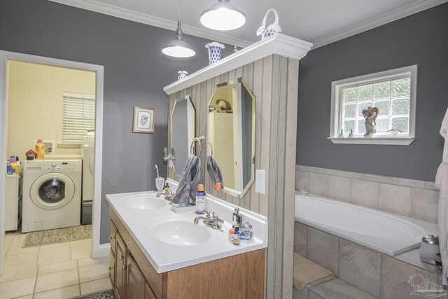 bathroom featuring washer / clothes dryer, tile patterned floors, ornamental molding, tiled bath, and vanity