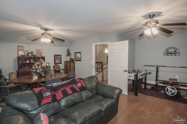 living room featuring dark hardwood / wood-style floors and ceiling fan