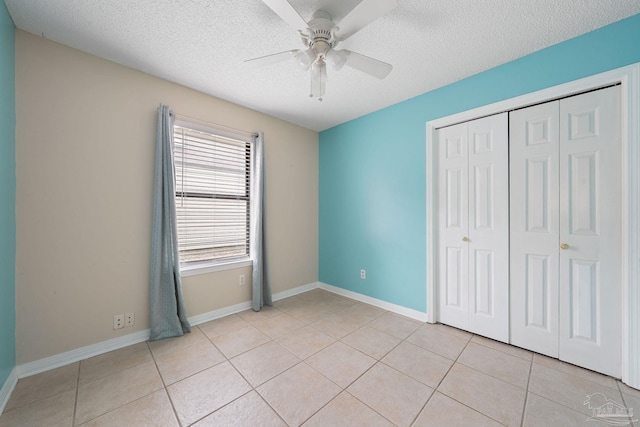 unfurnished bedroom featuring a textured ceiling, ceiling fan, and multiple windows