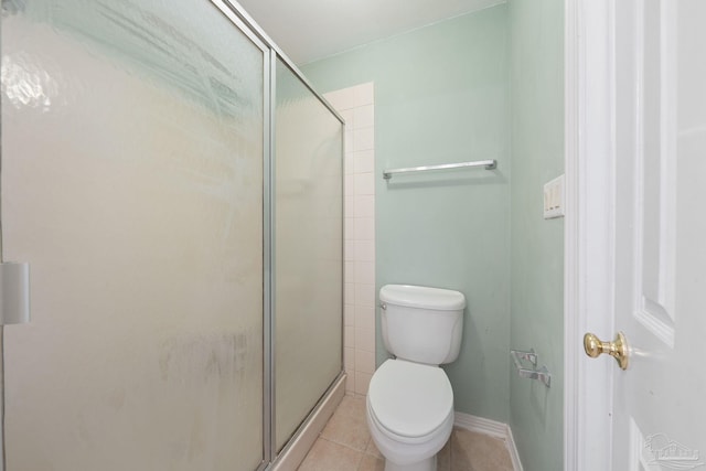 bathroom with a shower with door, tile patterned floors, and toilet