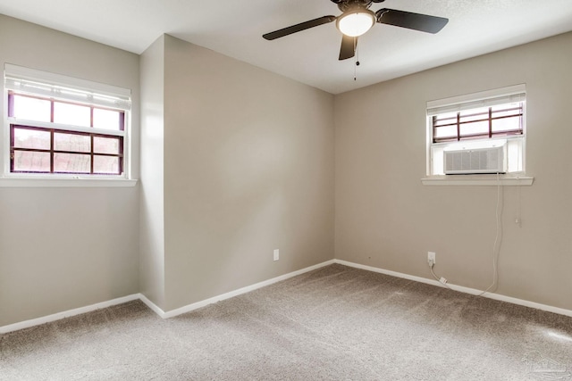 carpeted spare room featuring cooling unit, baseboards, and a ceiling fan