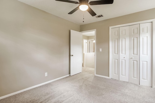 unfurnished bedroom featuring carpet, a closet, baseboards, and ceiling fan