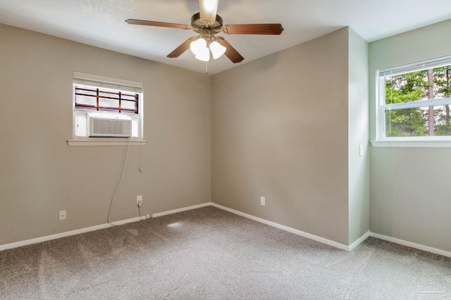 carpeted spare room featuring cooling unit, baseboards, and ceiling fan