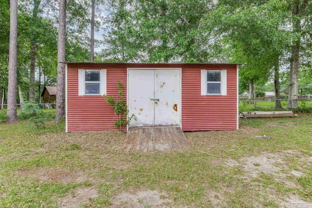view of shed featuring fence