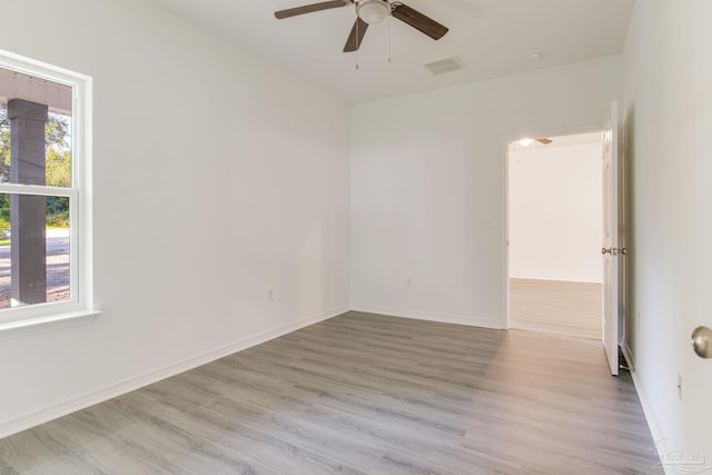 spare room featuring light hardwood / wood-style flooring and ceiling fan