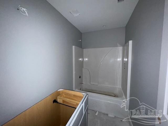 bathroom featuring shower / bathing tub combination and toilet