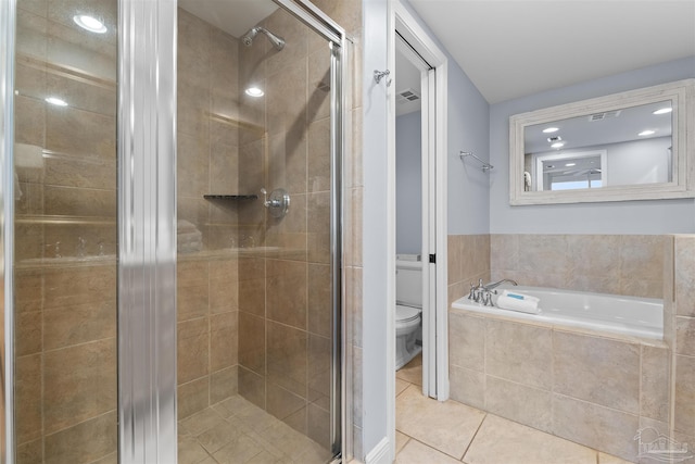 bathroom featuring independent shower and bath, tile patterned flooring, and toilet