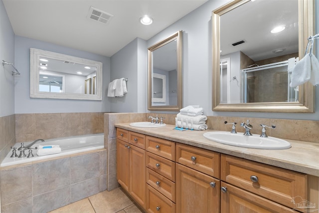 bathroom featuring vanity, tile patterned floors, and plus walk in shower