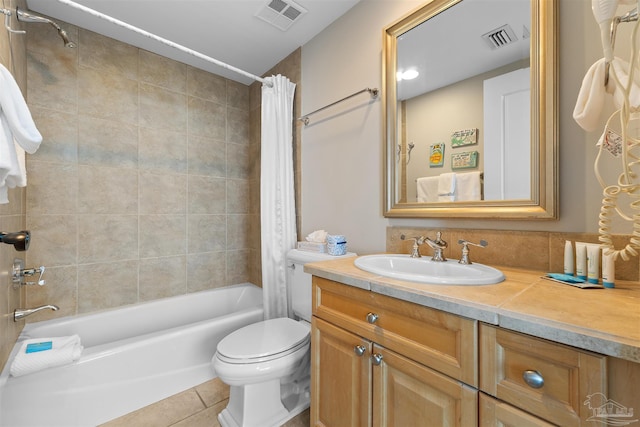 full bathroom featuring vanity, shower / tub combo with curtain, tile patterned flooring, and toilet