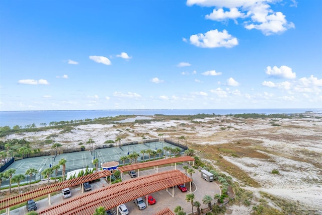 birds eye view of property with a water view and a view of the beach