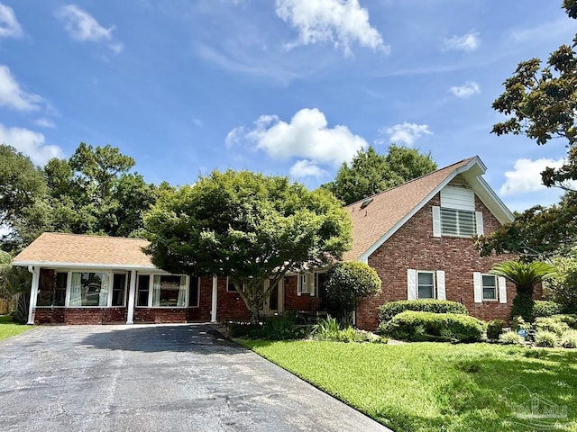 20 Magnolia Ave, Shalimar, FL 32579 - view of front of property featuring brick siding, a front lawn, and asphalt driveway