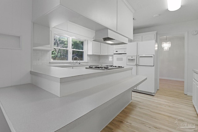 20 Magnolia Ave, Shalimar, FL 32579 - kitchen with white appliances, custom range hood, white cabinetry, and backsplash