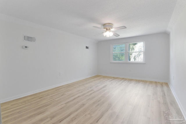 20 Magnolia Ave, Shalimar, FL 32579 - spare room with light wood finished floors, ceiling fan, and a textured ceiling