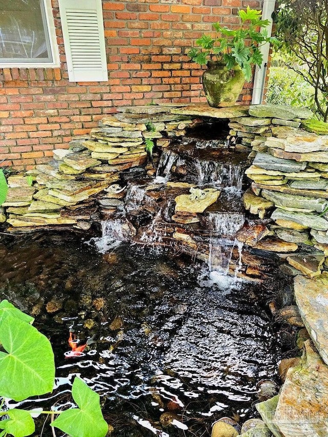 20 Magnolia Ave, Shalimar, FL 32579 - exterior view of brick siding and a small pond