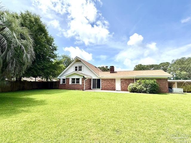 20 Magnolia Ave, Shalimar, FL 32579 - back of house featuring brick siding and a chimney