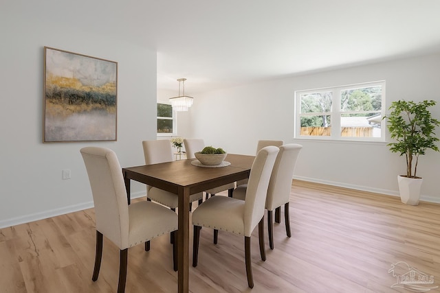 20 Magnolia Ave, Shalimar, FL 32579 - dining space featuring light wood-type flooring, healthy amount of natural light, and a chandelier