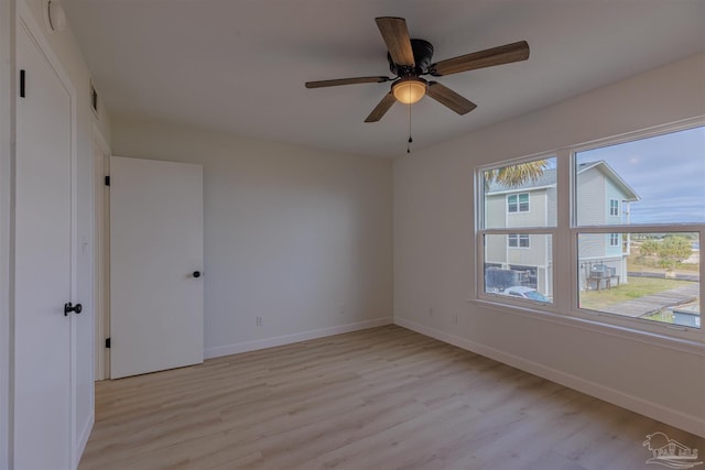 empty room featuring light hardwood / wood-style flooring and ceiling fan