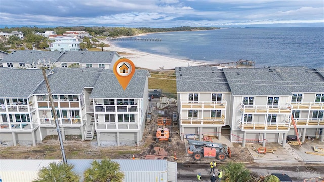 drone / aerial view with a water view and a beach view