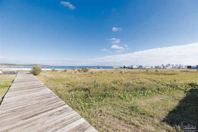 exterior space with a water view and a beach view