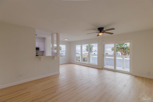 unfurnished living room featuring light hardwood / wood-style flooring and ceiling fan