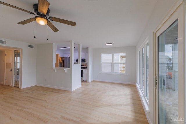 unfurnished living room with ceiling fan and light wood-type flooring